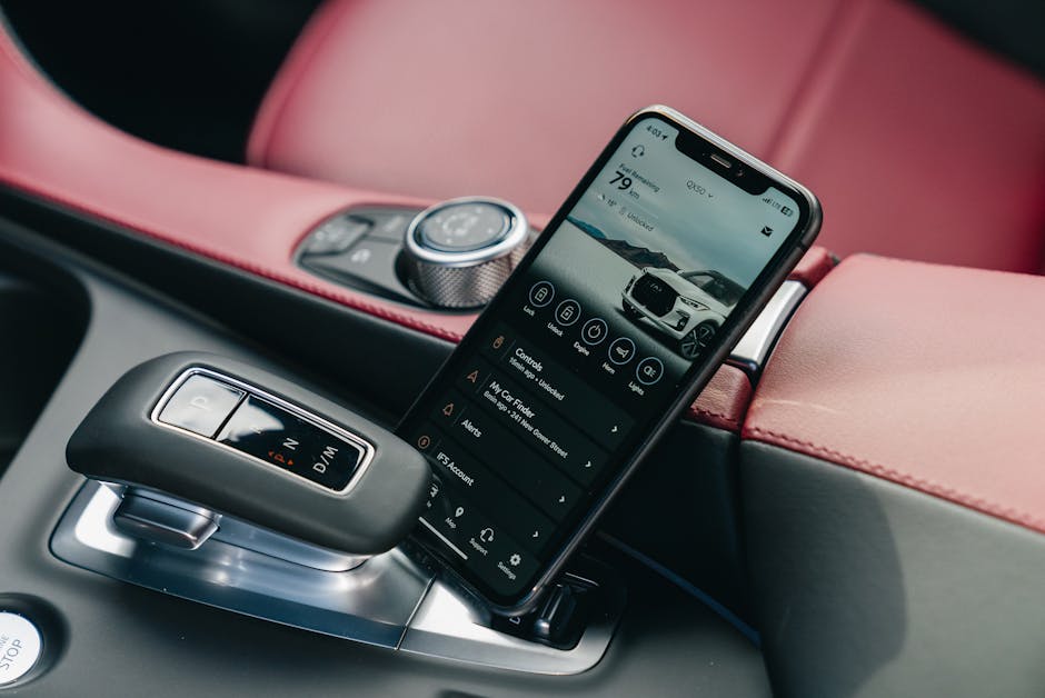 Close-up of smartphone with car control app in a luxury car's interior
