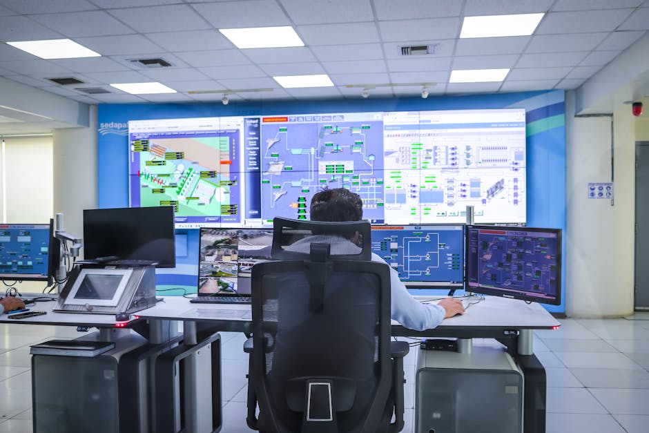 Operator in a modern control room managing technological systems